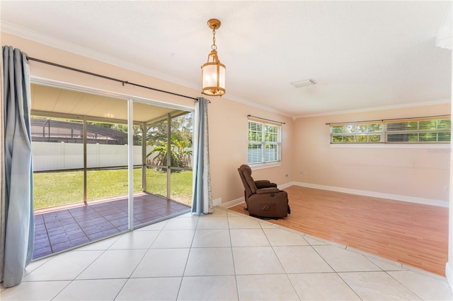unfurnished room featuring crown molding, light tile patterned floors, and baseboards