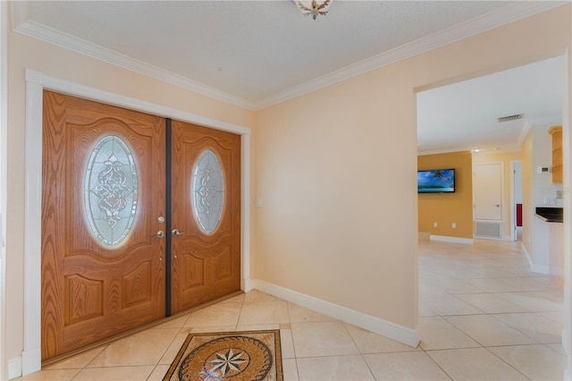 entrance foyer featuring visible vents, baseboards, ornamental molding, and light tile patterned flooring