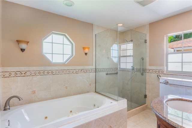 full bath with visible vents, tile walls, a shower stall, a jetted tub, and tile patterned floors