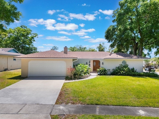 580 S Indigo Rd, Altamonte Springs, FL 32714 - single story home featuring stucco siding, a front lawn, an attached garage, a chimney, and driveway
