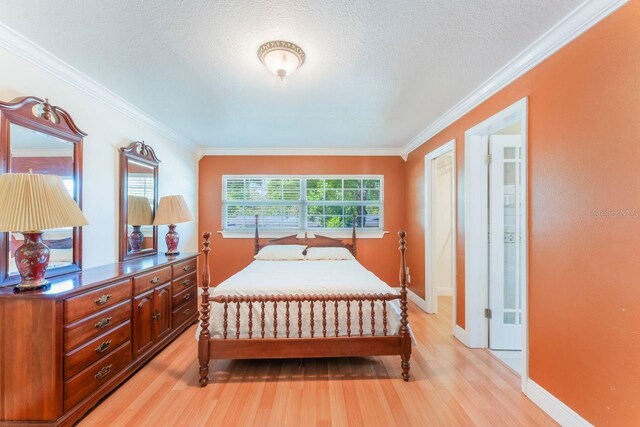580 S Indigo Rd, Altamonte Springs, FL 32714 - bedroom with light wood-style flooring, ornamental molding, and a textured ceiling