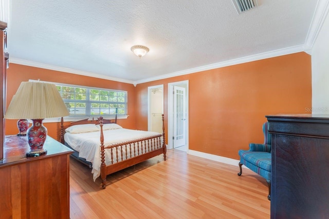 580 S Indigo Rd, Altamonte Springs, FL 32714 - bedroom with ornamental molding, light wood-style floors, and a textured ceiling
