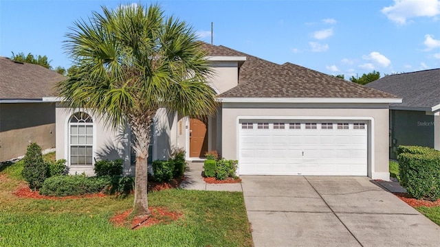 2237 Wyndham Palms Way, Kissimmee, FL 34747 - view of front of house featuring an attached garage, a shingled roof, concrete driveway, and stucco siding