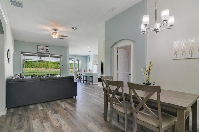 2237 Wyndham Palms Way, Kissimmee, FL 34747 - dining area with visible vents, wood finished floors, and ceiling fan with notable chandelier