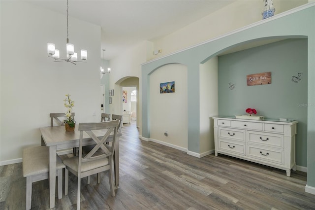 2237 Wyndham Palms Way, Kissimmee, FL 34747 - dining space with arched walkways, wood finished floors, an inviting chandelier, and baseboards