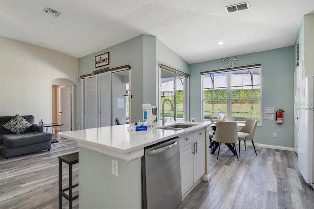 2237 Wyndham Palms Way, Kissimmee, FL 34747 - kitchen with stainless steel dishwasher, visible vents, freestanding refrigerator, and a sink