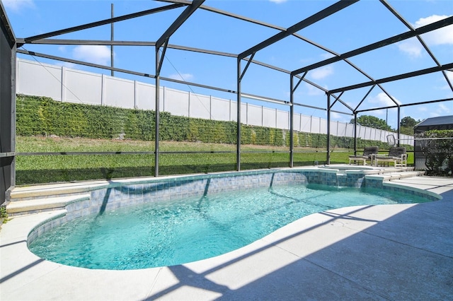 2237 Wyndham Palms Way, Kissimmee, FL 34747 - view of swimming pool featuring a pool with connected hot tub, fence, glass enclosure, and a patio