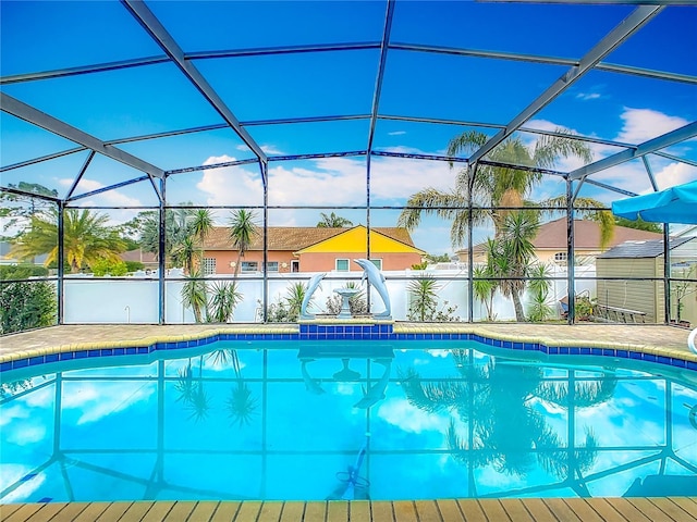 106 Meridian St, Davenport, FL 33837 - view of swimming pool featuring a storage shed, glass enclosure, a fenced in pool, and an outbuilding