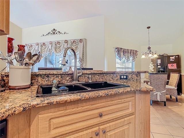 106 Meridian St, Davenport, FL 33837 - kitchen featuring a sink, a chandelier, light stone counters, decorative light fixtures, and light tile patterned floors