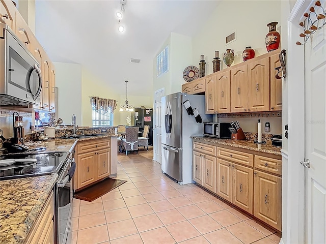106 Meridian St, Davenport, FL 33837 - kitchen with high vaulted ceiling, a sink, light tile patterned floors, stainless steel appliances, and visible vents