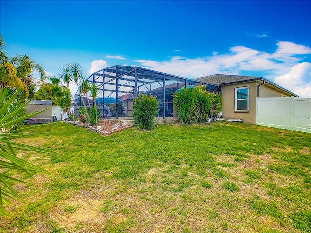 106 Meridian St, Davenport, FL 33837 - back of property with stucco siding, fence, glass enclosure, and a lawn