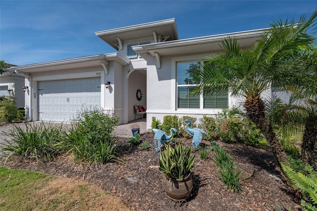 7957 Hanson Bay Pl, Kissimmee, FL 34747 - view of front facade with stucco siding, concrete driveway, and an attached garage
