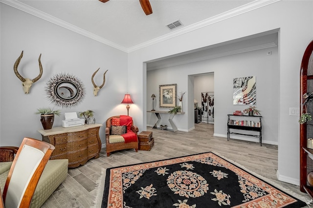 7957 Hanson Bay Pl, Kissimmee, FL 34747 - sitting room with crown molding, a ceiling fan, visible vents, baseboards, and wood finished floors