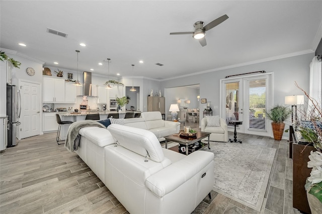7957 Hanson Bay Pl, Kissimmee, FL 34747 - living room featuring visible vents, light wood-type flooring, ceiling fan, and crown molding