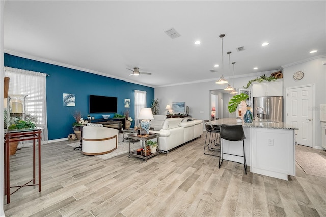 7957 Hanson Bay Pl, Kissimmee, FL 34747 - living area featuring visible vents, a ceiling fan, light wood finished floors, and crown molding
