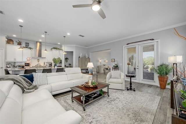 7957 Hanson Bay Pl, Kissimmee, FL 34747 - living area featuring recessed lighting, light wood-type flooring, a ceiling fan, visible vents, and ornamental molding