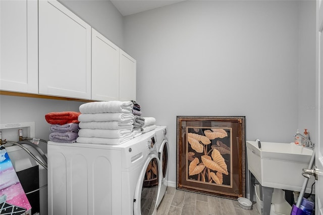 7957 Hanson Bay Pl, Kissimmee, FL 34747 - laundry room with light wood-type flooring, cabinet space, washing machine and clothes dryer, and a sink