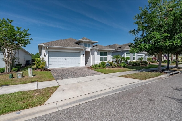 7957 Hanson Bay Pl, Kissimmee, FL 34747 - ranch-style house featuring stucco siding, driveway, a front yard, and a garage