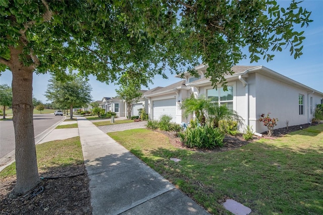 7957 Hanson Bay Pl, Kissimmee, FL 34747 - view of side of home with stucco siding, driveway, a yard, and a garage