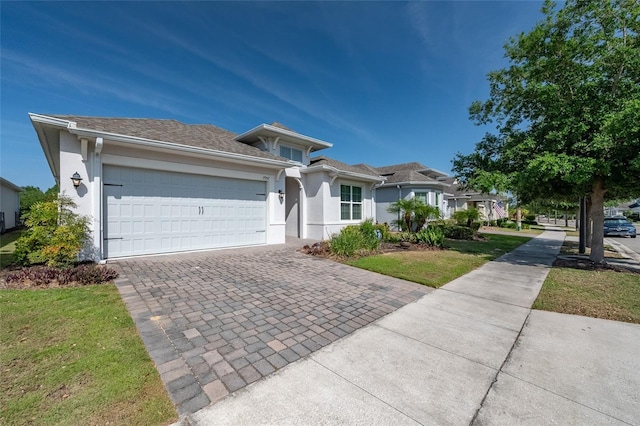 7957 Hanson Bay Pl, Kissimmee, FL 34747 - ranch-style house featuring stucco siding, decorative driveway, and an attached garage