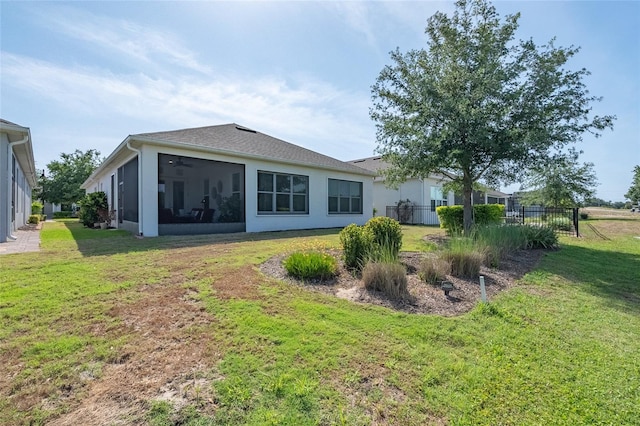 7957 Hanson Bay Pl, Kissimmee, FL 34747 - rear view of house with stucco siding, a sunroom, and a lawn