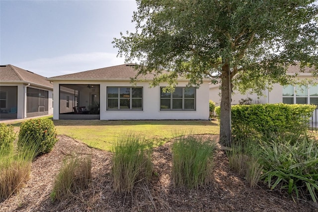 7957 Hanson Bay Pl, Kissimmee, FL 34747 - back of property featuring a ceiling fan, stucco siding, and a yard