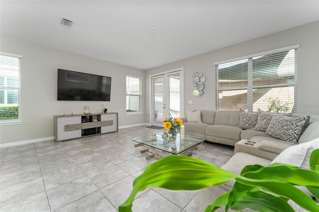 11162 Hanlon Terrace Aly, Winter Garden, FL 34787 - tiled living area featuring a wealth of natural light, visible vents, and baseboards