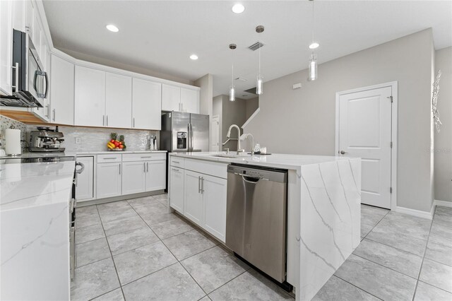 11162 Hanlon Terrace Aly, Winter Garden, FL 34787 - kitchen featuring appliances with stainless steel finishes, decorative backsplash, white cabinetry, and visible vents