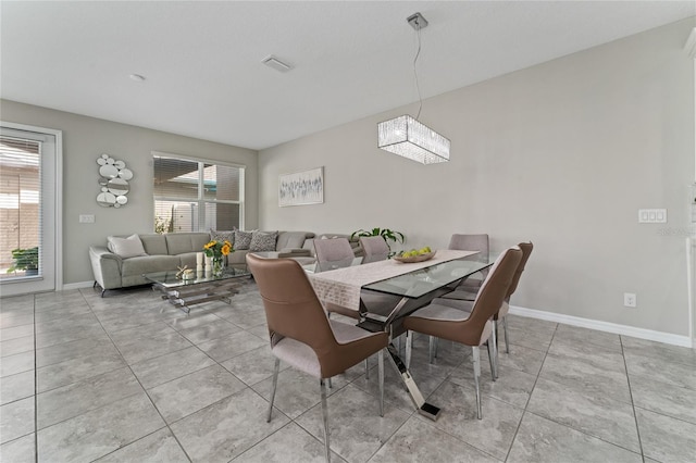 11162 Hanlon Terrace Aly, Winter Garden, FL 34787 - dining space with light tile patterned floors, visible vents, and baseboards