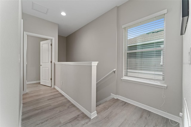 11162 Hanlon Terrace Aly, Winter Garden, FL 34787 - hall featuring visible vents, baseboards, an upstairs landing, and light wood finished floors