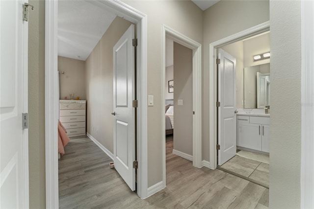 11162 Hanlon Terrace Aly, Winter Garden, FL 34787 - hallway with light wood-style flooring and baseboards
