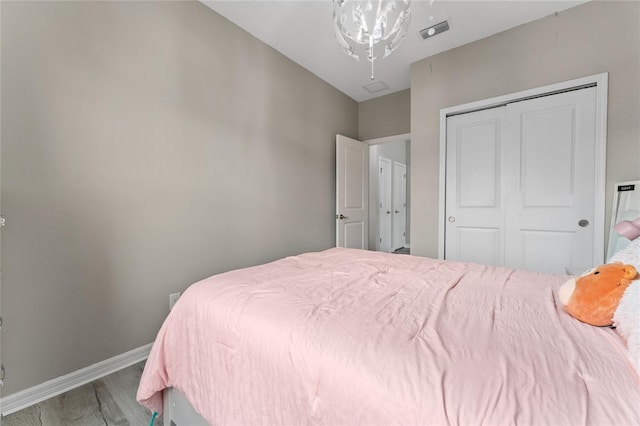 11162 Hanlon Terrace Aly, Winter Garden, FL 34787 - bedroom with a closet, visible vents, baseboards, and wood finished floors