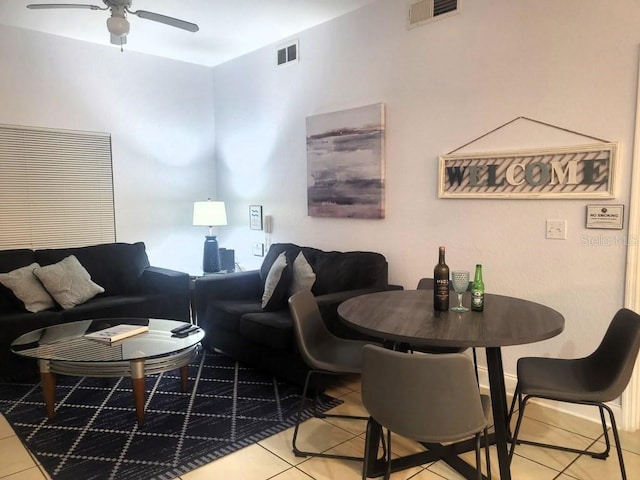 tiled living area with visible vents and a ceiling fan