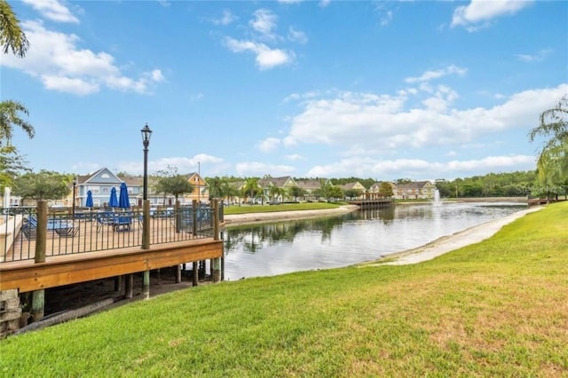 dock area with a yard and a water view