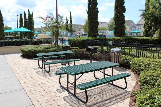 view of home's community with a patio and fence