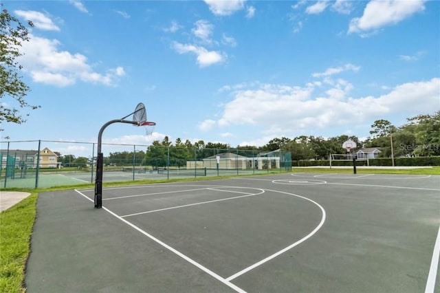 view of basketball court with community basketball court and fence