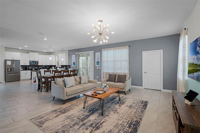 living room featuring baseboards, recessed lighting, and a chandelier