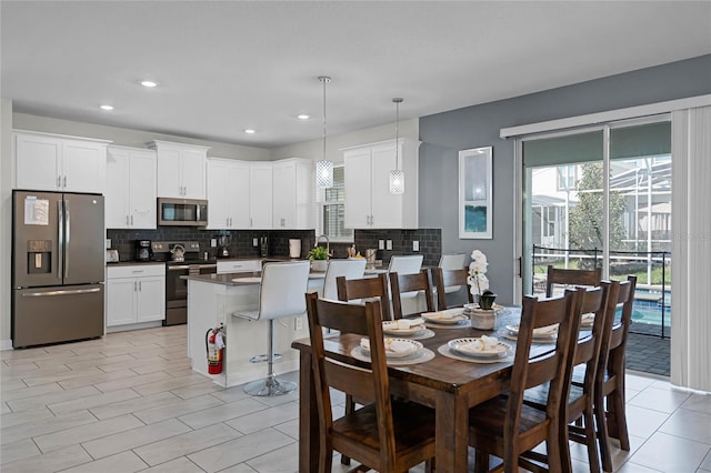 dining room featuring a wealth of natural light, recessed lighting, and light tile patterned floors