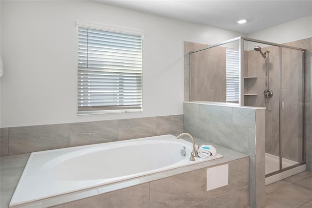 full bath featuring a stall shower and a garden tub