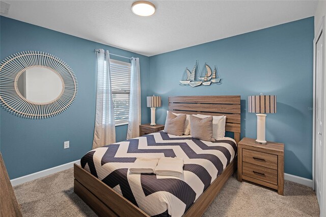 bedroom featuring carpet and baseboards