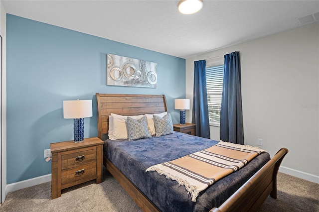 bedroom with carpet, visible vents, and baseboards