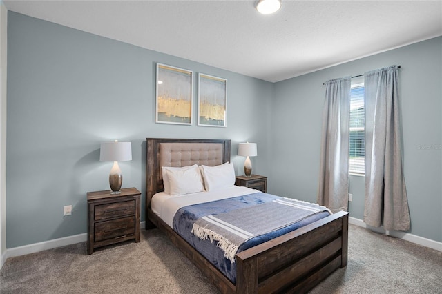 bedroom with baseboards and carpet floors