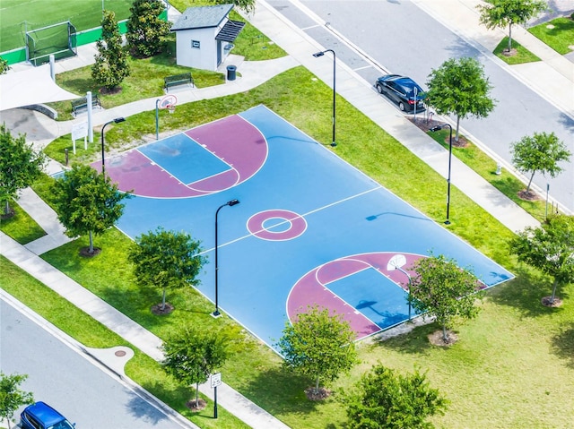 view of basketball court with community basketball court and a yard