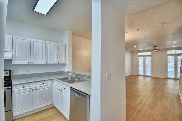 660 Celebration Ave Unit 240, Kissimmee, FL 34747 - kitchen with white cabinets, light countertops, dishwasher, a sink, and light wood-type flooring