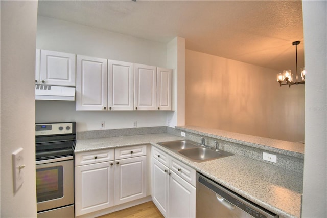660 Celebration Ave Unit 240, Kissimmee, FL 34747 - kitchen featuring a sink, white cabinetry, a chandelier, under cabinet range hood, and appliances with stainless steel finishes
