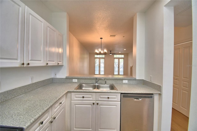 660 Celebration Ave Unit 240, Kissimmee, FL 34747 - kitchen with white cabinets, light countertops, a sink, a chandelier, and dishwasher