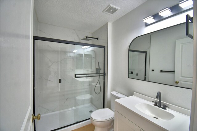 660 Celebration Ave Unit 240, Kissimmee, FL 34747 - full bath featuring a marble finish shower, a textured ceiling, toilet, visible vents, and vanity