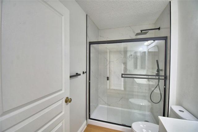 660 Celebration Ave Unit 240, Kissimmee, FL 34747 - full bath featuring a textured ceiling, toilet, vanity, and a marble finish shower