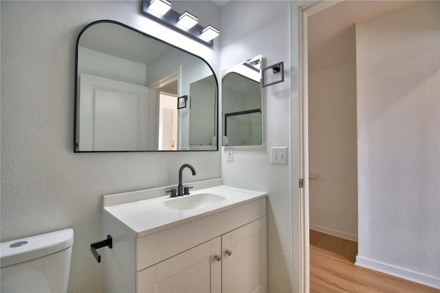 660 Celebration Ave Unit 240, Kissimmee, FL 34747 - bathroom with toilet, vanity, wood finished floors, and baseboards