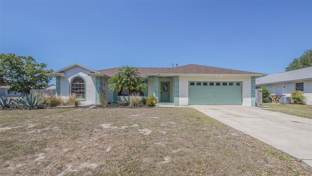 ranch-style home featuring central AC unit, a garage, stucco siding, a front lawn, and driveway